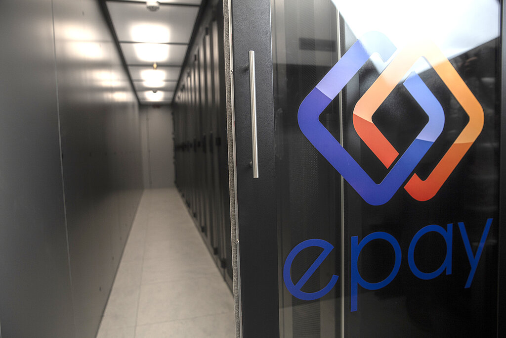 Data center with server aisle and logo of EPAY on the glass door